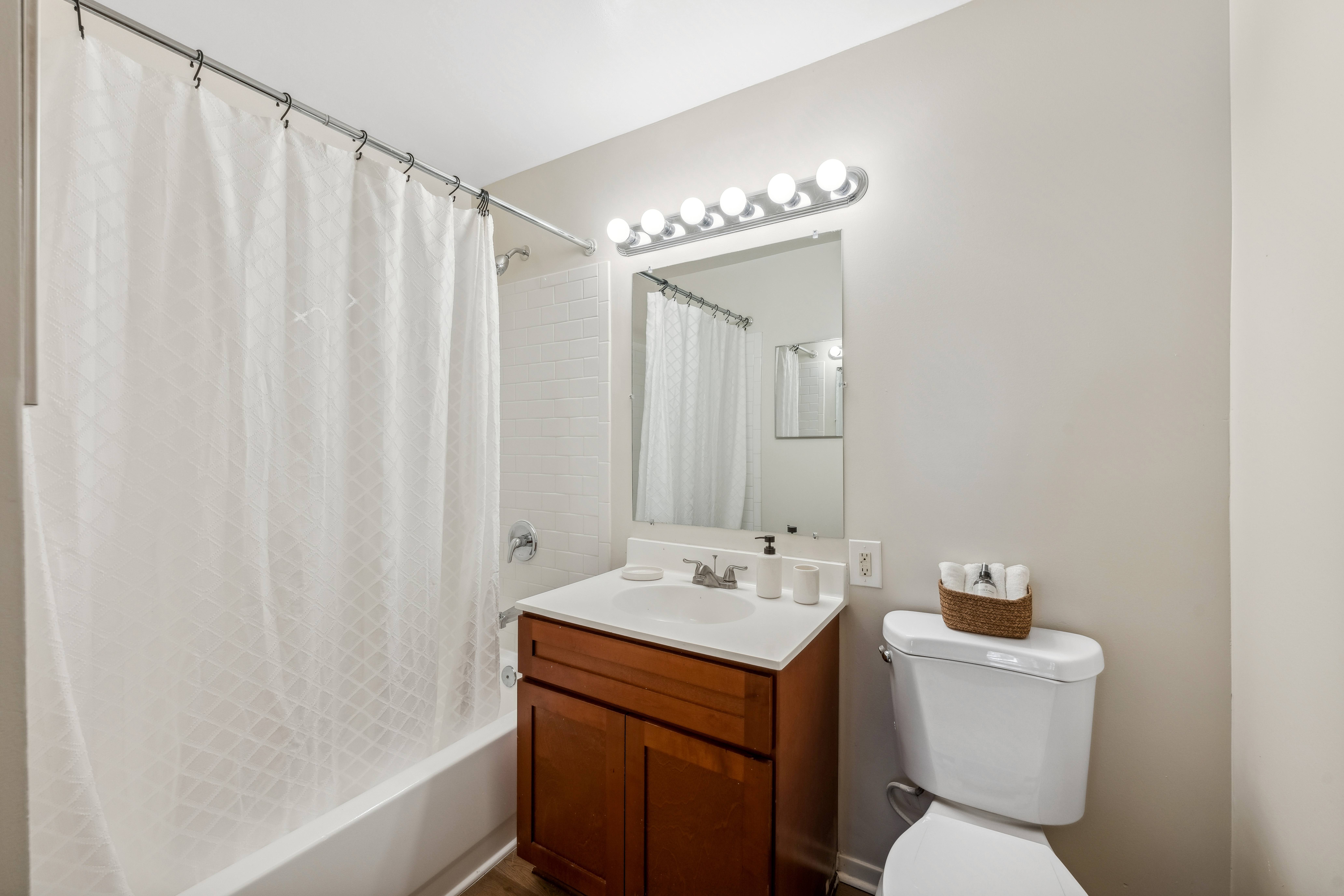 A white toilet sits next to a sink in a bathroom.